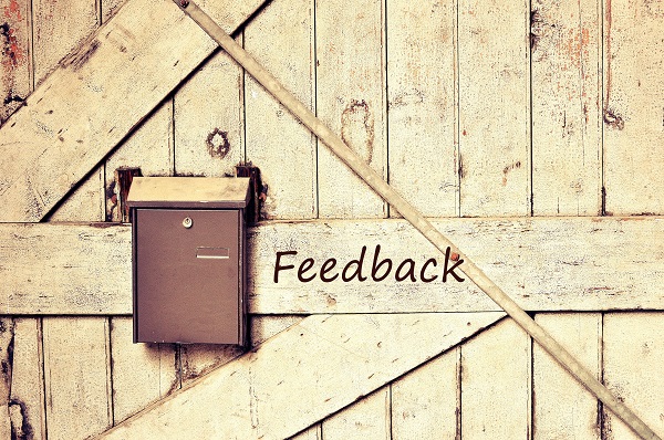 feedback box hanging at a wooden wall