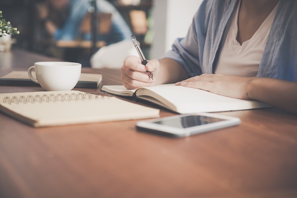 woman sitting in a cafe and learning